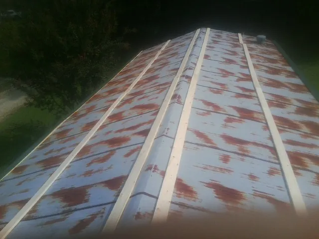 Rusted metal roof panels with new wood purlins before replacement — Storm Damage Roof Repair in Randle by Roofing Brothers